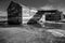 Dramatic high contrast image image of old weathered wooden storage barns on a salt mine on caribbean coast.