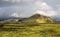 Dramatic iceland landscape with a green hill and black lava looks like a moon. Serenity of Iceland