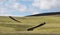 Dramatic iceland landscape with a green hill and empty road