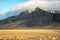 Dramatic Icelandic landscape - mountain surrounded by clouds