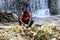 Dramatic image of dominican cleaning fish at waterfalls of san rafael park, dominican republic.