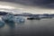 Dramatic image of icebergs in Jokulsarlon lagoon at the evening. South Iceland