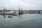 Dramatic image of a marina with boats in Bodega Bay, California. With water reflections.