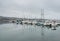 Dramatic image of a marina with boats in Bodega Bay, California. With water reflections.
