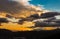 Dramatic image of orange and yellow and blue sunset in the mountains of the caribbean.