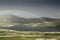 Dramatic landscape with beautiful rainbow over arctic meadows, mountain and lake.