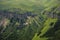 Dramatic landscape of a green valley at the foot of the Inal Plateau in the North Caucasus