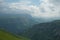 Dramatic landscape of a green valley at the foot of the Inal Plateau in the North Caucasus