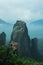 Dramatic landscape of Meteora monastery in morning fog.