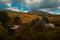 Dramatic landscape rural village in October fall season time highland mountain environment space smoke from chimney