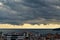 Dramatic landscape of stormy sky over small seaside city. The sky turned yellow before the storm. Dark nimbostratus clouds hang