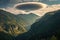 dramatic lenticular cloudscape above a forested mountain valley