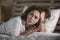 Dramatic lifestyle portrait of attractive sad and depressed middle aged around 50s woman feeling upset alone on bed suffering