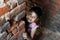 Dramatic look of a child. Portrait of a child. A child is playing Hide-and-seek on the top of the stairs.