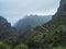 Dramatic lush green landscape with winding curvy mountain road towards Masca village situated in a picturesque valley