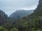 Dramatic lush green landscape with winding curvy mountain road towards Masca village situated in a picturesque valley