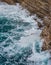 Dramatic marine background. Rocky coast of Adriatic Sea. White foamy waves beat against stone shore. Panorama of sea coast. Aerial