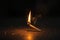 A dramatic moment a matchstick lights up a brown wooden surface