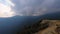 Dramatic moody sky covered with heavy low clouds and mountain background at morning