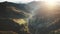 Dramatic mountain sunset aerial flight. Drone top view of autumn pine tree forest and yellow meadows
