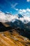 Dramatic Mountains and Clouds with Curvy Serpentine Road in Valley, Austria