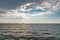 Dramatic ocean waves with sunrays peeking out of clouds off the coast of Thailand. Islands can be seen in the backdrop