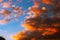 Dramatic orange clouds at sunset. Cloudscape abstract background photo.