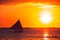 Dramatic orange sea sunset with sailboat. Summer time. Travel to Philippines. Luxury tropical vacation. Boracay paradise island.