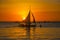 Dramatic orange sea sunset with sailboats in tropical country, clouds. Philippines, Boracay