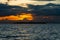 Dramatic orange tinged Sunset in the Bohol Strait. Silhoutte of Bugatusan Island, a small inhabited islet off the town of Clarin