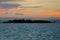 Dramatic orange tinged Sunset in the Bohol Strait. Silhoutte of Hambongan Island, a small inhabited islet off the town of Clarin