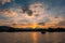 Dramatic panorama evening sky and clouds over mountain and lake at sunset