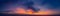 Dramatic panorama of late sunset with burning sky