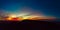 Dramatic panoramic image of the sunset over volcan Calderon Hondo volcano near Lajares