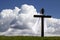 Dramatic photo illustration of Easter Morning with brilliant clouds, deep blue sky and large wooden cross, with shroud and crown o