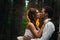 Dramatic picture bride and groom on the background of leaves forest backlight