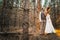 Dramatic picture bride and groom on the background of leaves forest backlight