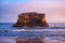 Dramatic pink sunset over Natural Bridges State Beach in Santa Cruz, California, USA. Amazing landscape with natural stone rock