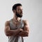 Dramatic portrait of confident strong handsome bearded athlete with crossed arms