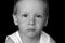 Dramatic portrait of kid looking at camera with angry face, Emotional photo of Displeased boy with unhappy face, Head