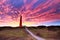 Dramatic purple mammatus clouds over lighthouse