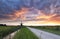 Dramatic purple sunset in Dutch countryside with windmill