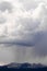 Dramatic rain storm clouds over snowy mountains