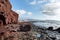 Dramatic red colored cliffs on the coast of Montana Roja mountain near El Medano, Tenerife, Canary Islands, Spain,