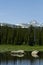 Dramatic Red Rock Lake with huge stones, forest, and mountains