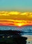 Dramatic red sunset behind a stage on the promenade of Westerland, Sylt, where seagulls sit