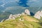 Dramatic rocky peaks set against forested mountain range