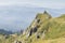 Dramatic rocky peaks set against a misty mountain range