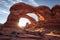 dramatic sandstone arch illuminated by golden sunlight