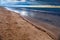 Dramatic scenery empty long sandy beach with cloudy storm sky